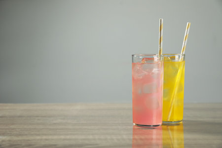Delicious refreshing drinks on gray table. Space for textの写真素材