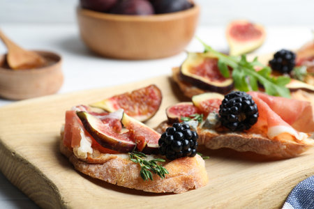 Sandwiches with ripe figs and prosciutto served on wooden board, closeupの写真素材