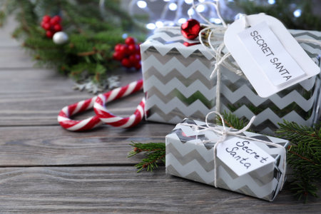 Presents from secret Santa on wooden table, space for textの写真素材