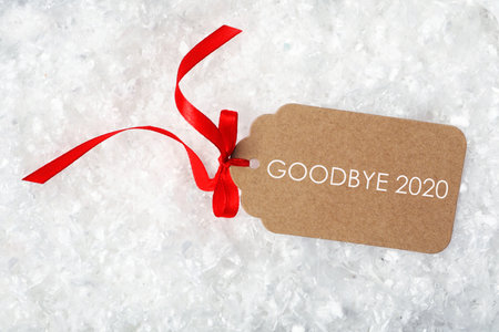 Tag with text Goodbye 2020 on light background, top viewの写真素材