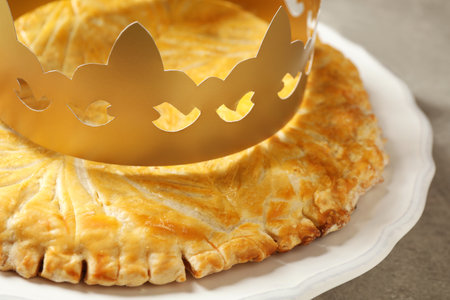 Traditional galette des Rois with paper crown on table, closeupの写真素材