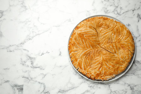 Traditional galette des rois on white marble table, top view. Space for textの写真素材