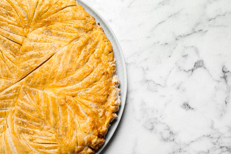 Traditional galette des rois on white marble table, top view. Space for textの写真素材