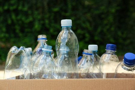 Cardboard box with used plastic bottles outdoors. Recycle conceptの写真素材