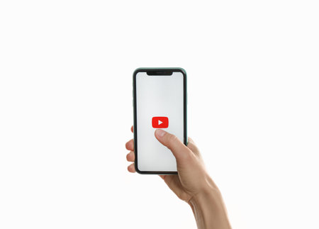 MYKOLAIV, UKRAINE - JULY 9, 2020: Woman holding iPhone 11 with Youtube app on screen against white background, closeupのeditorial素材