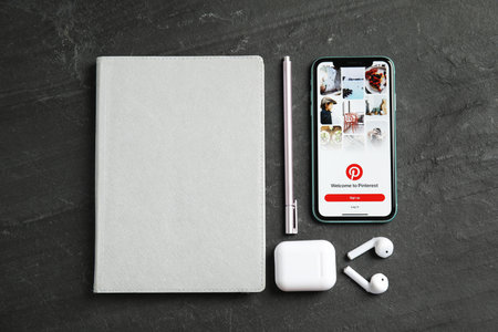 MYKOLAIV, UKRAINE - JULY 9, 2020: Flat lay composition and Iphone 11 and AirPods on black backgroundのeditorial素材