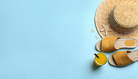 Beach accessories on light blue background, flat lay. Space for textの写真素材