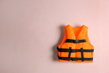 Orange life jacket on pink background. Space for textの写真素材