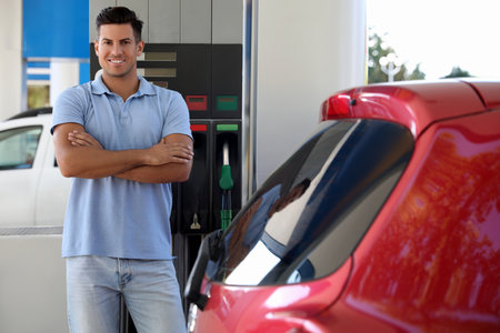 Man near car at self service gas stationの写真素材