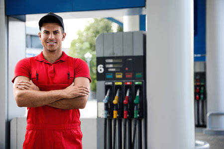 Worker in uniform at modern gas stationの写真素材