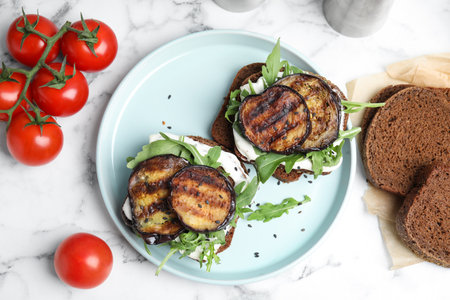 Delicious eggplant sandwiches served on white marble table, flat layの写真素材