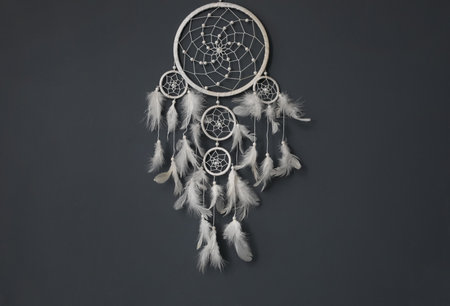 Beautiful dream catcher hanging on black wall