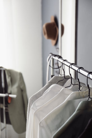 Rack with stylish men's clothes indoors, closeup. interior designの写真素材