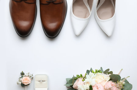 Composition with wedding shoes for bride and groom on white background, top viewの写真素材