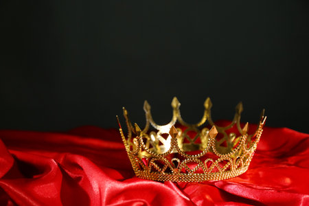 Beautiful golden crown on red fabric. fantasy itemの写真素材