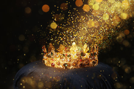 fantasy world. Beautiful golden crown lit by magic light on pillowの写真素材