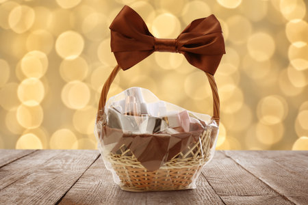 Wicker basket full of cosmetic products on table against blurred festive lightsの写真素材
