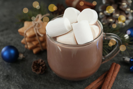 Delicious cocoa drink with marshmallows and Christmas decor on gray table, closeupの写真素材