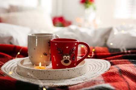 Christmas cups in tray on red woolen blanket. interior decorの写真素材