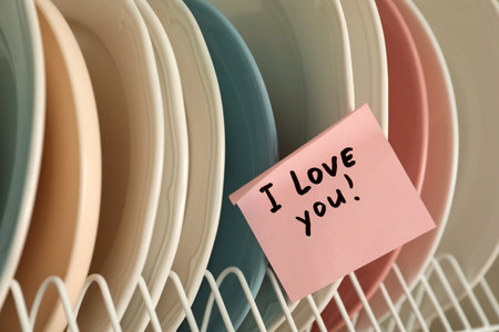 Sticky paper with words I Love You on clean platesの写真素材