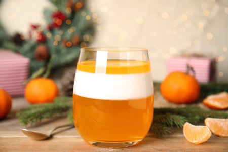Delicious tangerine jelly in glass on wooden table, closeupの写真素材