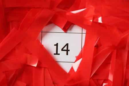 Red confetti on calendar with number 14, closeup. Valentine's Day celebrationの写真素材