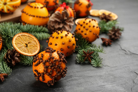 Pomander balls made of fresh tangerines with cloves on dark table, space for text. christmas atmosphereの写真素材