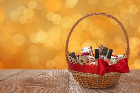 Wicker basket full of cosmetic products on table against blurred festive lights. Space for textの写真素材