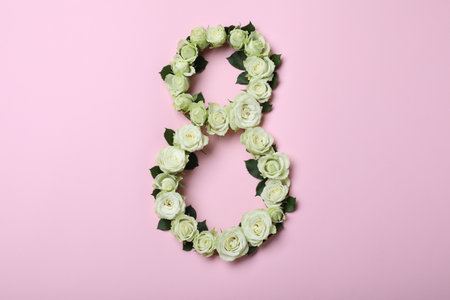 Number 8 made with white roses on pink background, flat lay. International Women's dayの写真素材