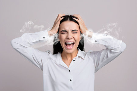 Stressed and upset young woman on light gray background