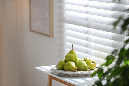 Fresh ripe pears on white table in room. Space for textの写真素材