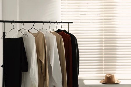 Rack with stylish men's clothes indoors. interior designの写真素材