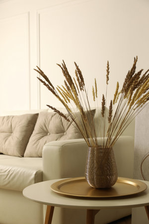 Fluffy reed plumes on table in living room interiorの写真素材