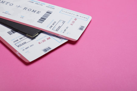 Tickets and passports on pink background, space for text. travel agency conceptの写真素材