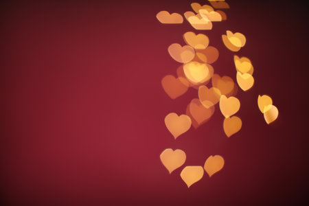 Blurred view of beautiful lights on burgundy background, space for text. bokeh effectの写真素材