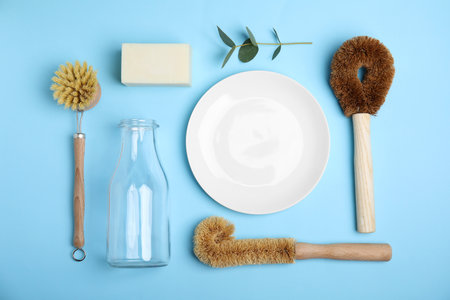 Flat lay composition with cleaning supplies for dish washing on light blue background, flat layの写真素材