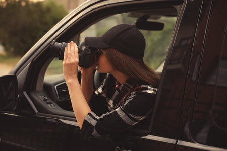 Private detective with camera spying from carの写真素材