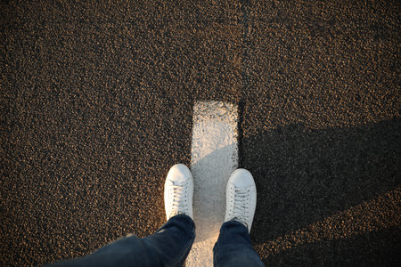 Top view of man standing on road with white line, space for text. way concept