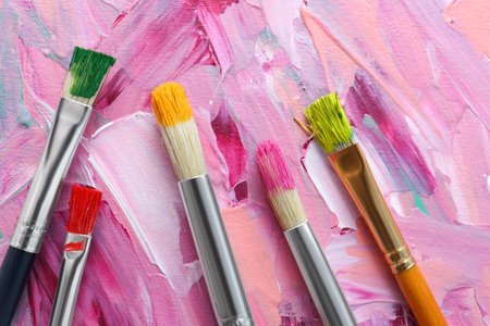 Set of different brushes on abstract colorful paint, flat layの写真素材