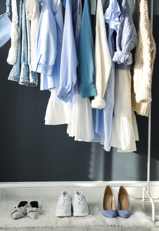 Rack with stylish women's clothes indoors. interior designの写真素材