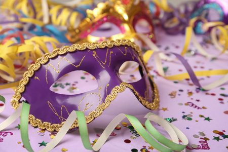 Beautiful carnival mask and party decor on violet background, closeupの写真素材