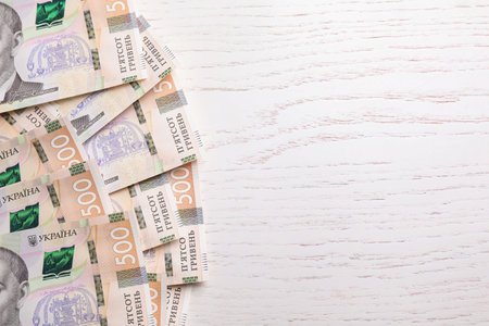 Ukrainian money on wooden background, flat lay. Space for textの写真素材