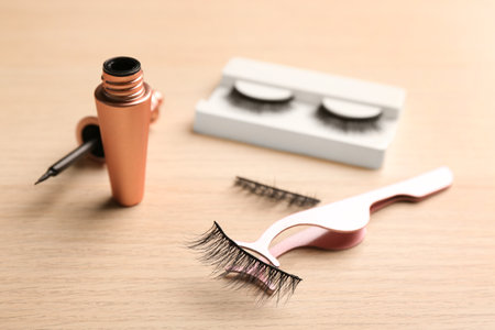 Magnetic eyelashes and accessories on wooden tableの写真素材