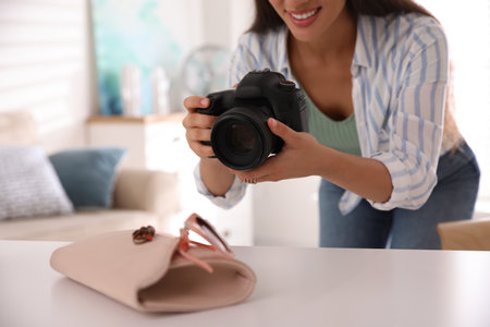 Young photographer taking picture of accessories indoors, closeupの写真素材