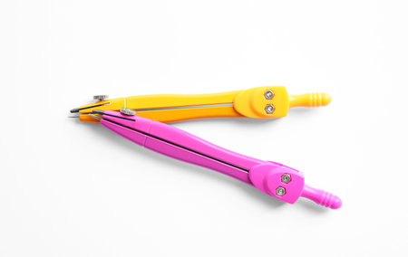 Colorful compasses on white background, top view. school stationeryの写真素材