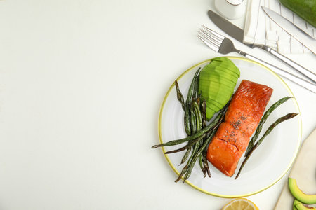 Tasty cooked salmon and vegetables served on white table, flat lay with space for text. Healthy meals from air fryerの写真素材