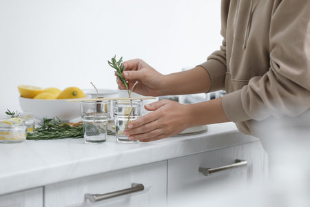 Woman making natural mosquito repellent candles at white table, closeupの写真素材