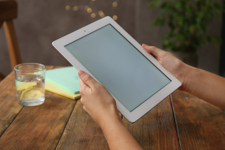 Woman using new modern tablet indoors, closeupの写真素材