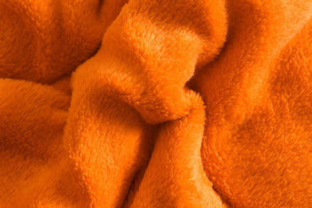 Fluffy crumpled orange fabric as background, top viewの写真素材