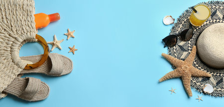 Beach accessories and space for text on light blue background, flat lay. Banner designの写真素材